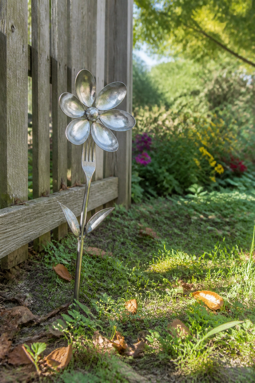 12 Yard Decorations DIY Projects for 2026 1 A metal flower crafted from a spoon with a fork stem.