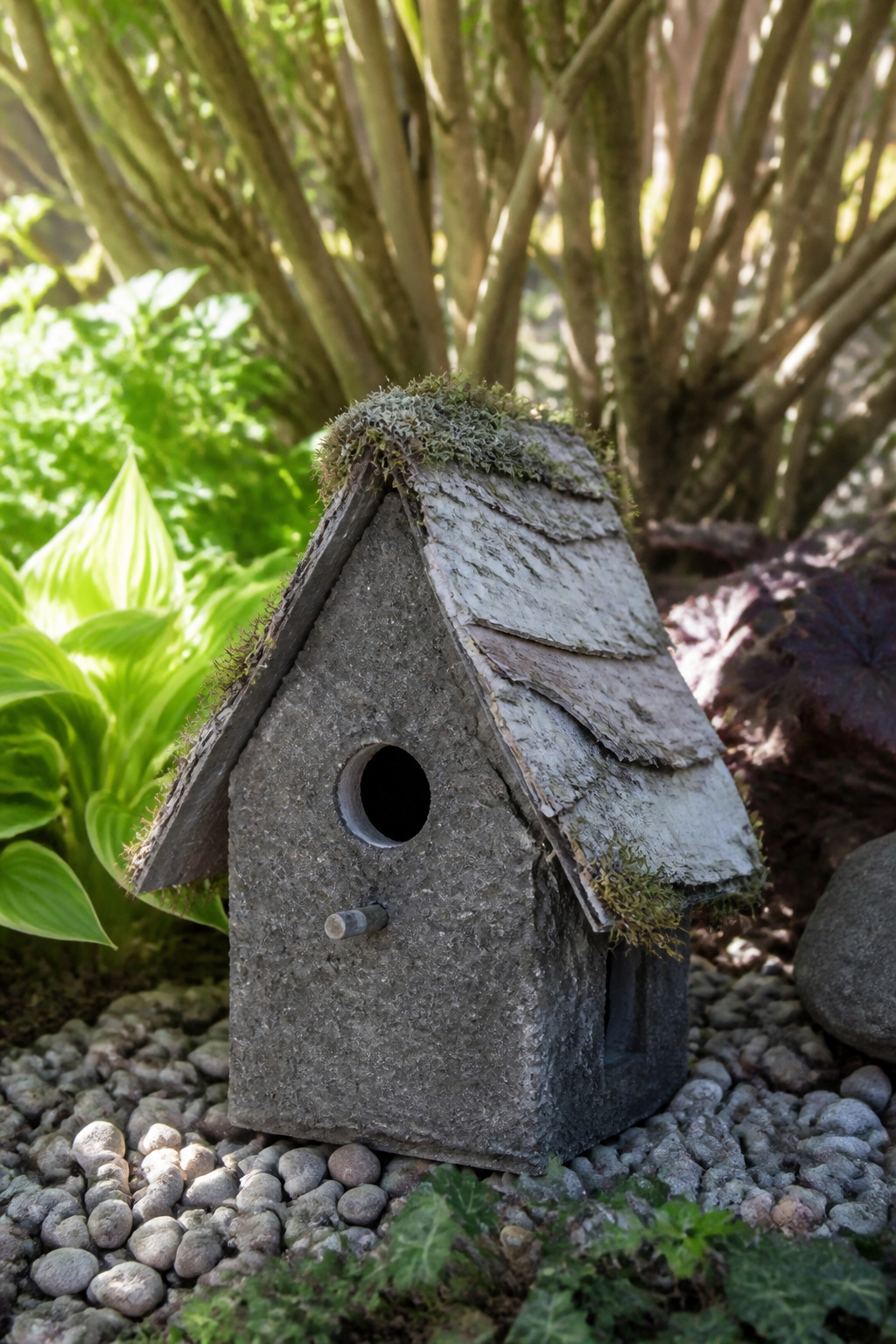 DIY Garden Fairy House: 20 Ways to Build One 1 Concrete fairy house with a birch bark roof in a sunny garden.