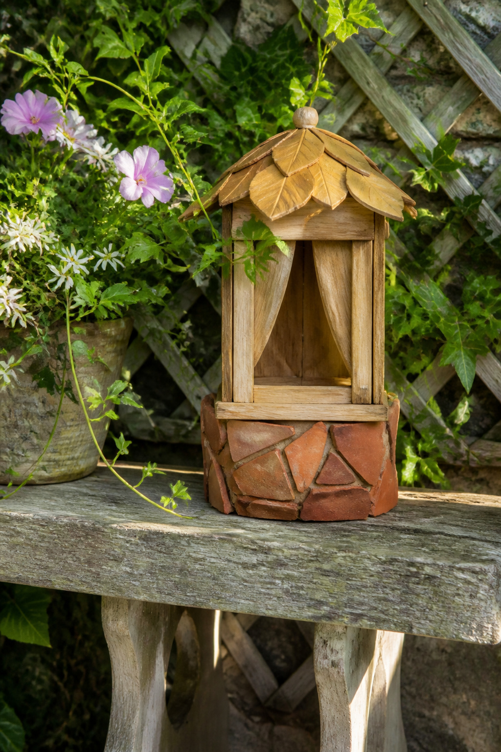 DIY Garden Fairy House: 20 Ways to Build One 12 Wooden fairy house on a garden bench surrounded by plants.