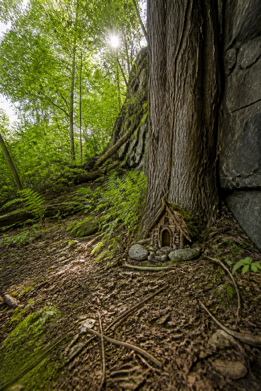 DIY Garden Fairy House: 20 Ways to Build One 19 Foraged fairy house made from twigs and moss in a garden.