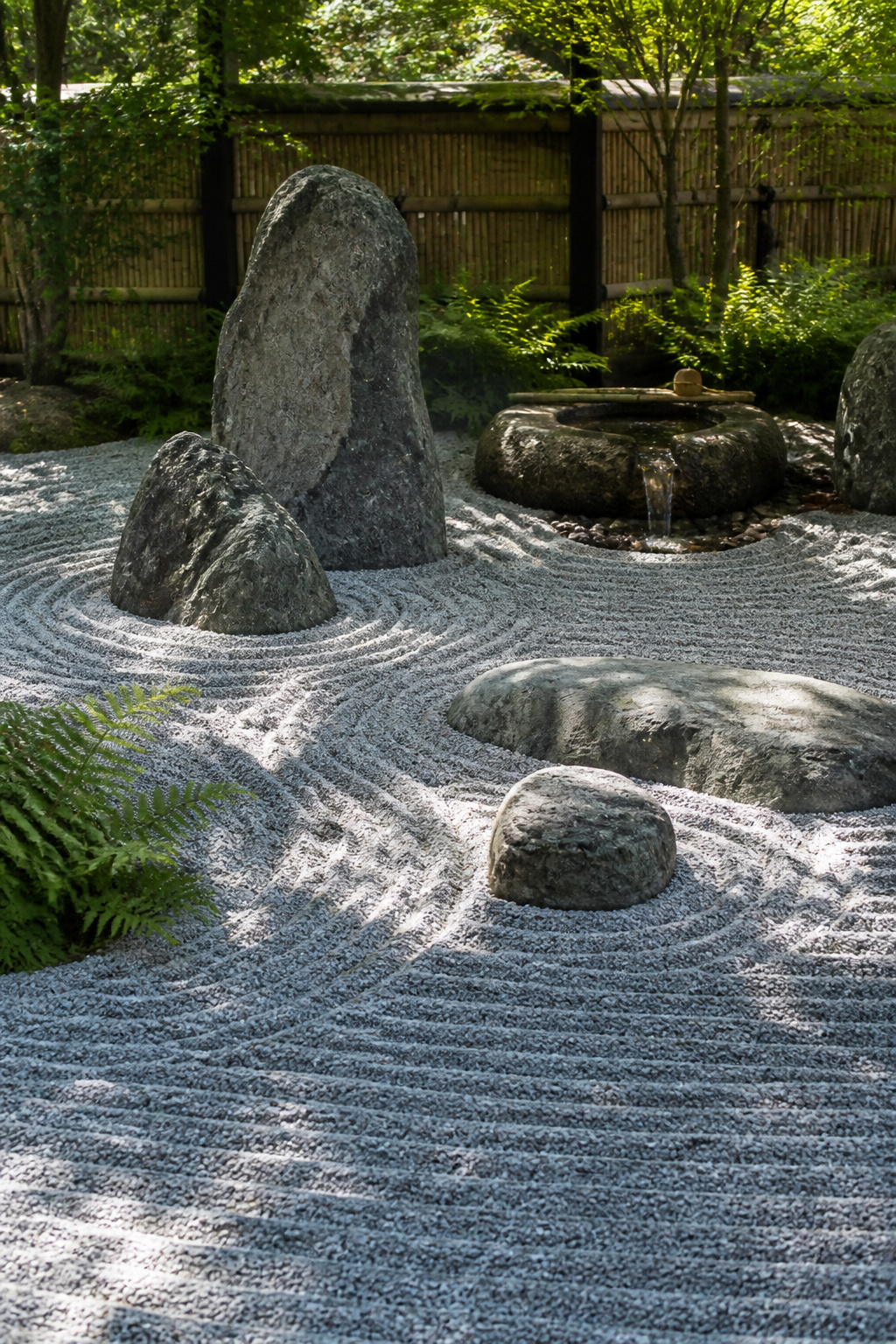 Zen garden featuring raked gravel patterns and large stones.