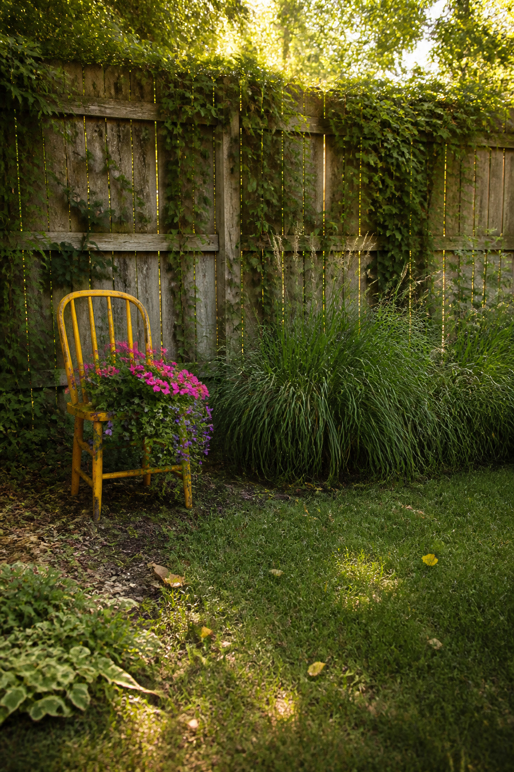 12 Yard Decorations DIY Projects for 2026 4 A broken chair repurposed as a planter for flowers.