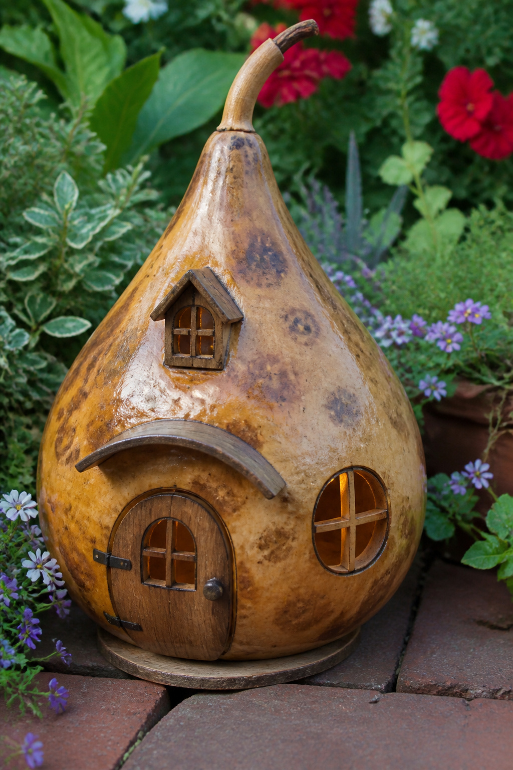 DIY Garden Fairy House: 20 Ways to Build One 6 Dried gourd fairy house with a door and windows cut out.